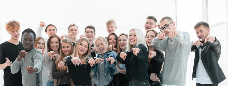 group of confident young people pointing at you