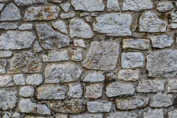 Old granite stone wall texture background close up