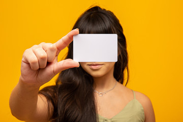 Young woman hand hold blank white card mockup with rounded corners. Plain call-card mock up...