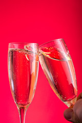clink glasses two glasses with white wine champagne on a colored background