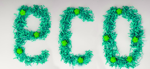 word eco from shredded paper concept of economical use of resources, happy new year, recycling, separate garbage collection. Eco-friendly concept. Word ECO is made from green, on white background