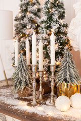 Closeup of candles in candlekeeps standing on wooden desk. Selective focus.