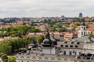 Beautiful autumn panorama of Vilnius old town with colorful hot air balloons in the sky, taken from the Gediminas hill