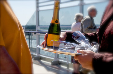 Crew serving bottle of Champagne on luxury cruise ship ocean liner