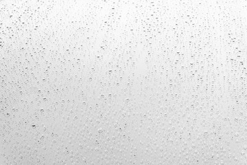 Raindrop water dew drop on glass wet white gray blue background.