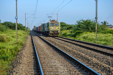 Fototapeta na wymiar Pune, India - November 10 2019: Freight train hauled by an electric locomotive Pune India.