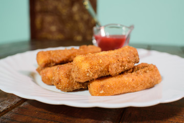 Cheese sticks on a large and beautiful wooden table