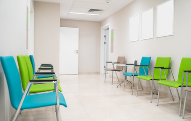 Esthetic and clean modern private clinic or vet waiting room with empty posters