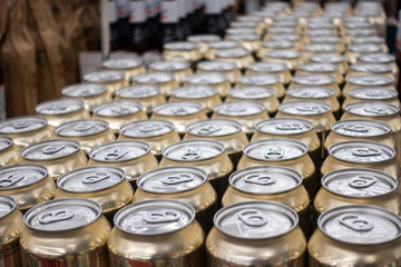 Many metal cans with cool drinks. A group of objects.