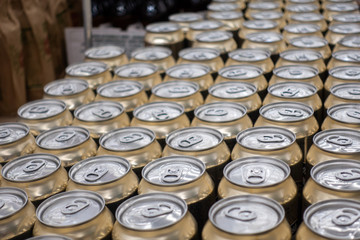 Many metal cans with cool drinks. A group of objects.
