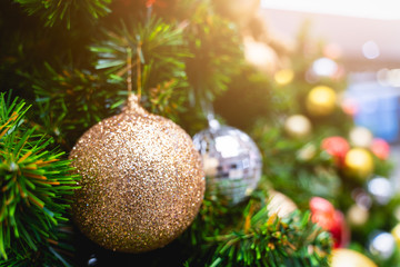 Close up Chistmas tree and New Year decoratetion , Baubles hanging with colorful blur bokeh background and copy space in christmas new year and celebrate concept,soft tone Soft focus.