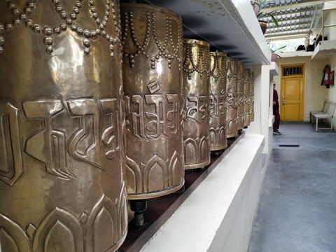 Mcleodganj, Himachal Pradesh/India- September 20 2019: Buddhist prayer wheels made up of metal. A tibetan monastry on mountains.