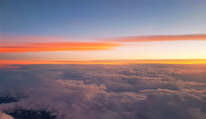 flying above the clouds in the evening