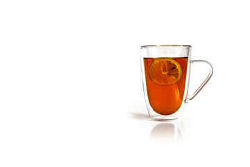 Mug of hot black tea with lemon isolated on white background