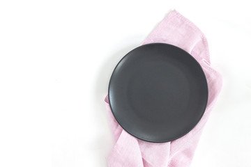 Empty black plate on dark stone background.