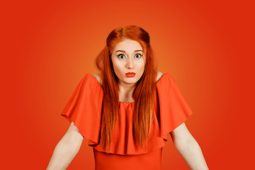 Confused looking woman shrugging shoulders