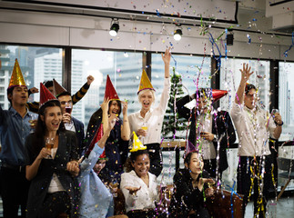 Smiling young Business people on New Year Party in Office and drinking champagne for New Year...