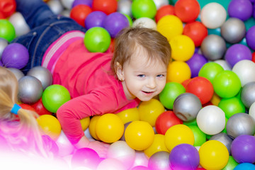 Fototapeta na wymiar little girl playing in kindergarten or at home in the nursery