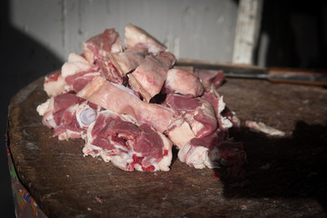Meat or butcher shop at vintage or old market. Fresh meat on wooden stump.
