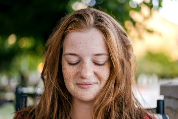 Portrait of a beautiful girl with red wet hair after bathing without makeup. Confident Natural Beauty Concept