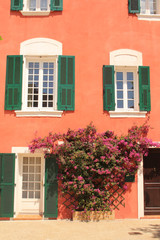 Fototapeta na wymiar Traditional houses with colorful facades and wooden window shutters in the historic center of Martigues, the Little Venice of Provence, France 