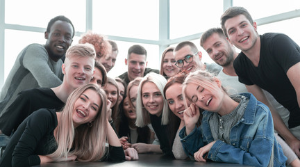 large group of cheerful friends sitting at the table