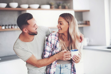 happy young couple in kitchen in good morning time