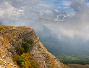mount slope, mountain valley in a dense clouds