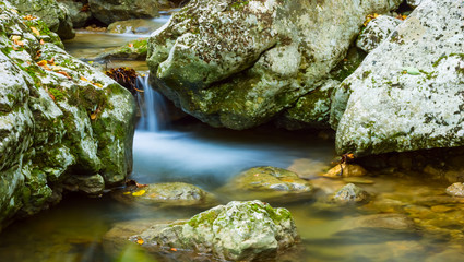 closeup small waterfall on a mountain river