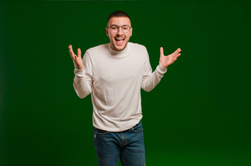 young handsome man feeling happy, excited, surprised or shocked, smiling and astonished at...