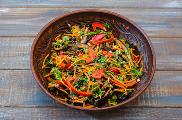 Salad of sweet pepper, fried eggplant, onions, carrots, spices, garlic, vegetable oil and vinegar. Korean food.