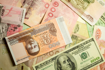 A lots of a money of different countries: USA, Russia, Thailand and Cambodia. Flat lay background with copyspace for a text.