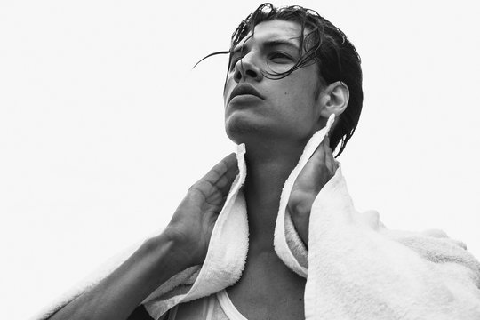 Muscle strong beautiful stripped male model portrait on isolated font background with shadow