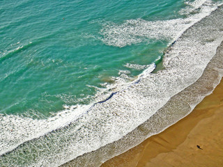aerial view of waves on a beach