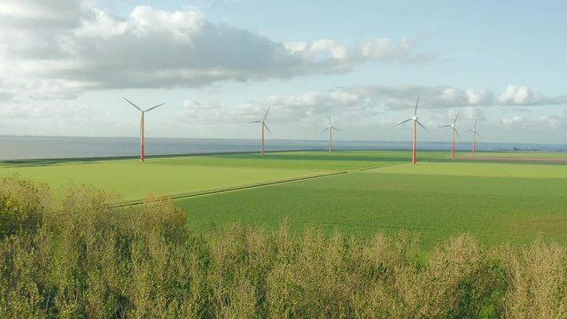 Wind turbines generating green sustainable energy in Almere Pampus, Flevoland, The Netherlands. Aerial view. 