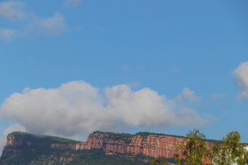 Fototapeta na wymiar Blue Sky and Clouds over Rocky Mountain Hill