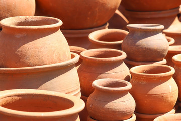 Fototapeta na wymiar Handmade Orange Colored Clay Pots made on Pottery Wheels Round shaped for Storing Water Curd or Liquid
