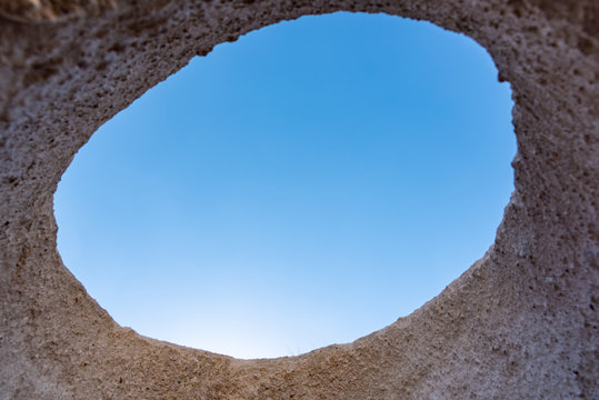 View From Circle Hole In Volcanic Rock Formation In Cappadocia National Park Of Goreme.