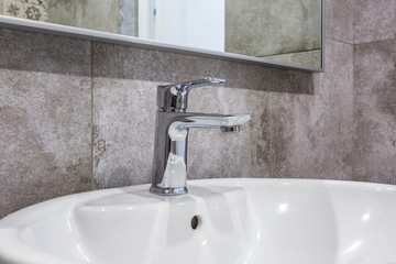 steel water tap sink with faucet in expensive loft bathroom