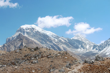 Fototapeta na wymiar View of Chola (Kangchung La) mountain peak from the hill in Himalayas in Sagarmatha national park. The summit is covered with snow and ice. Route to Everest base camp in Nepal through Gokyo lakes.