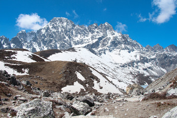Fototapeta na wymiar View of Pharilapche mountain (6017 meters) in Sagarmatha national park in Himalayas. The lake is visible on the right at the foot of the mountain. Route to Everest base camp through Gokyo lakes.