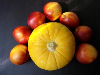 Yellow pumpkin and some nectarines. Still-life. Food.