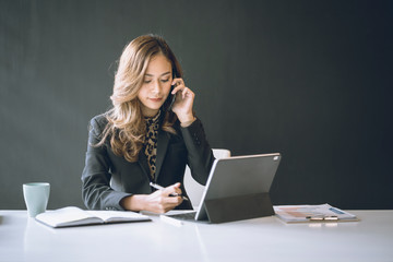 Portrait of comfident young  entrepreneur businesswoman working in modern work station.