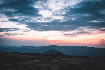 Sunset behind mountains in national park Krkonose, Czech Republic