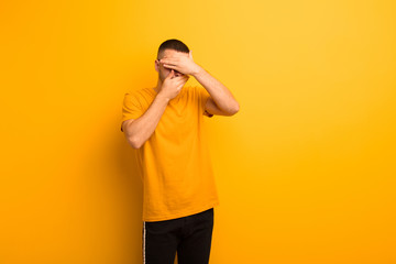 young handsome man covering face with both hands saying no to the camera! refusing pictures or...