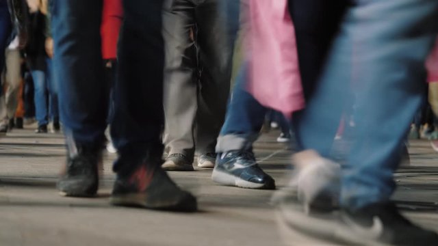 Timelapse: crowd of people pedestrians walk cross big city at night. Footsteps of crowd of people, busy city street.