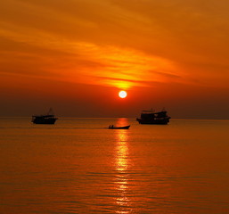 summer. Beautiful natural background of sunset with fishing boat on vacation