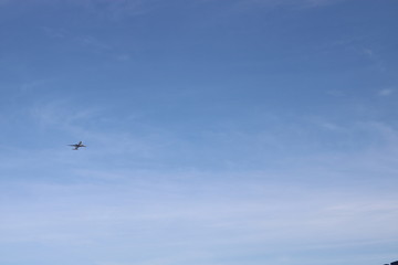 A plane taking off in the distance against the blue evening sky.