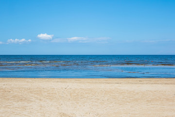 Fototapeta na wymiar Three colors of Jurmala: golden sand on Dzintari, deep blue of Baltic sea and azure of Latvian sky. Famous Dzintari beach in Jurmala, Latvia