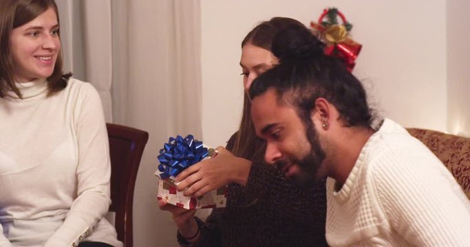 Young man is disappointed by present at Christmas party - slow motion - shot on RED